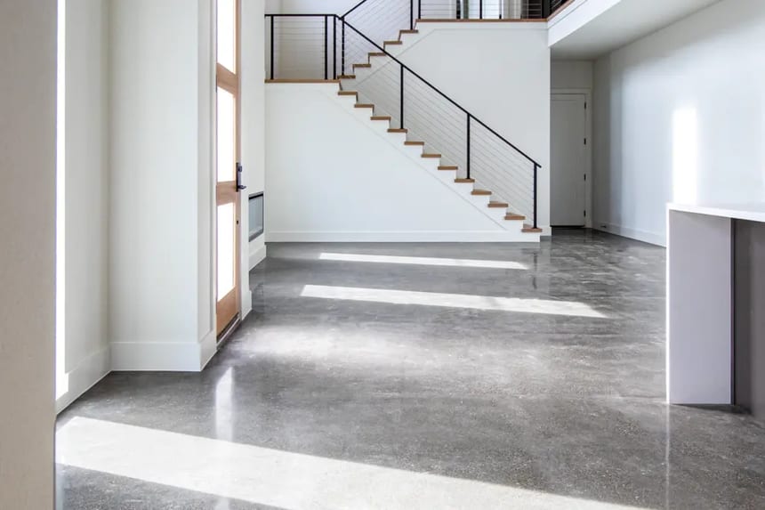 Lightly ground salt and pepper polished concrete floor in luxury residential setting Salt and pepper polished concrete floor in modern home with exposed aggregate and satin finish