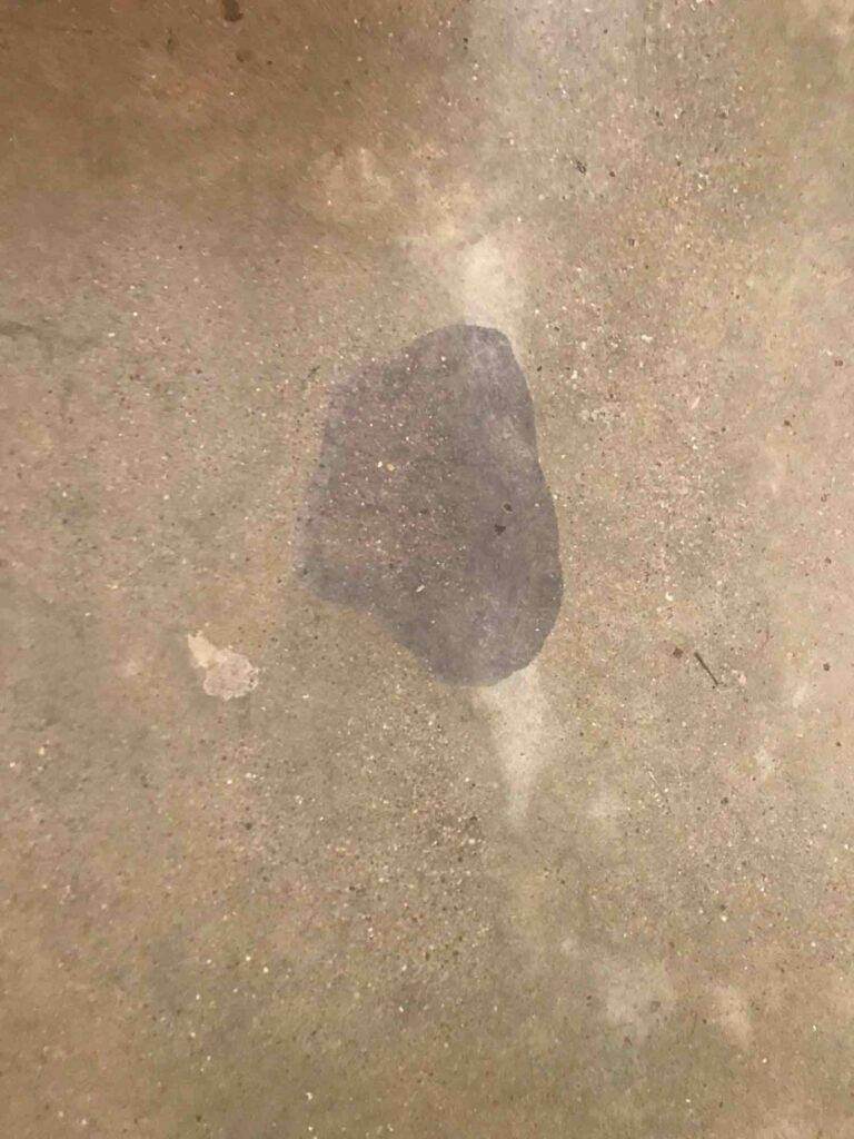 A red wine stain on a polished concrete floor. This spill was left overnight, and has colored the surface of the floor. This area had to be re-polished to resolve the stain.