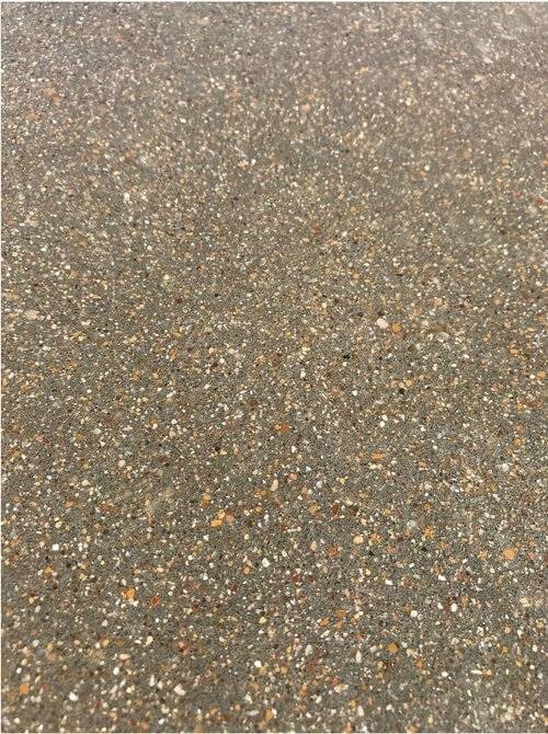 Small aggregate exposure ‘Class B” Craftsman Concrete Floor. This picture was taken after the cut but before polishing. The aggregate used is ‘native’ rock. Notice the bright colors and consistent exposure this rock facilitates.